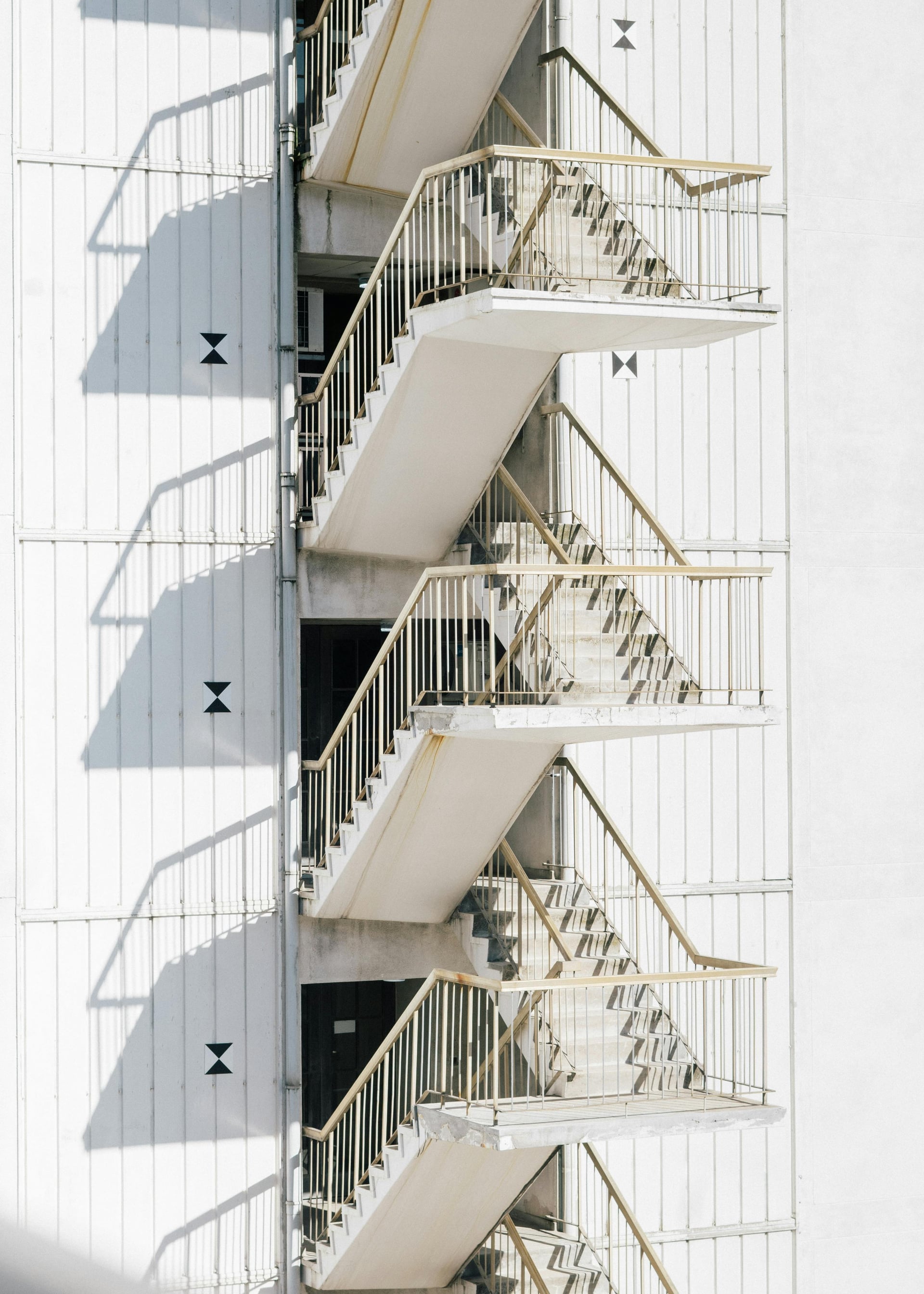 Repeating exterior staircase on a white building